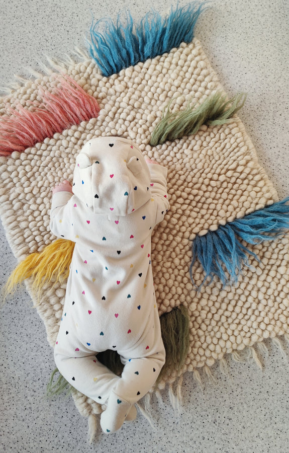 Child playing on the soft woolen Zhvanchyk Gulki textured rug