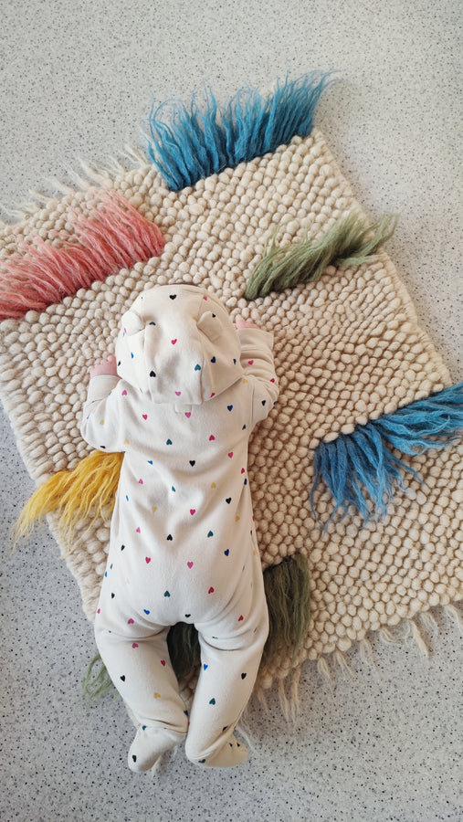 Child playing on the soft colored woolen Zhvanchyk Gulki textured rug