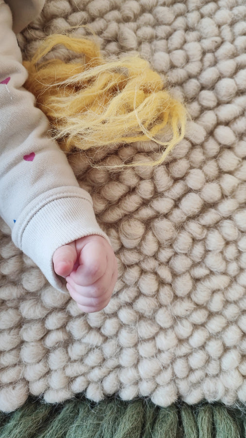 Close-up of the handwoven wool texture of the Zhvanchyk Gulki rug