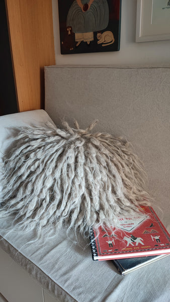 Artisanal wool pillow styled in minimalist living room