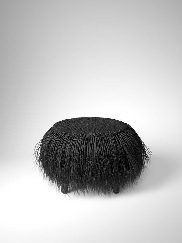 Minimalist black wool pouf on white background
