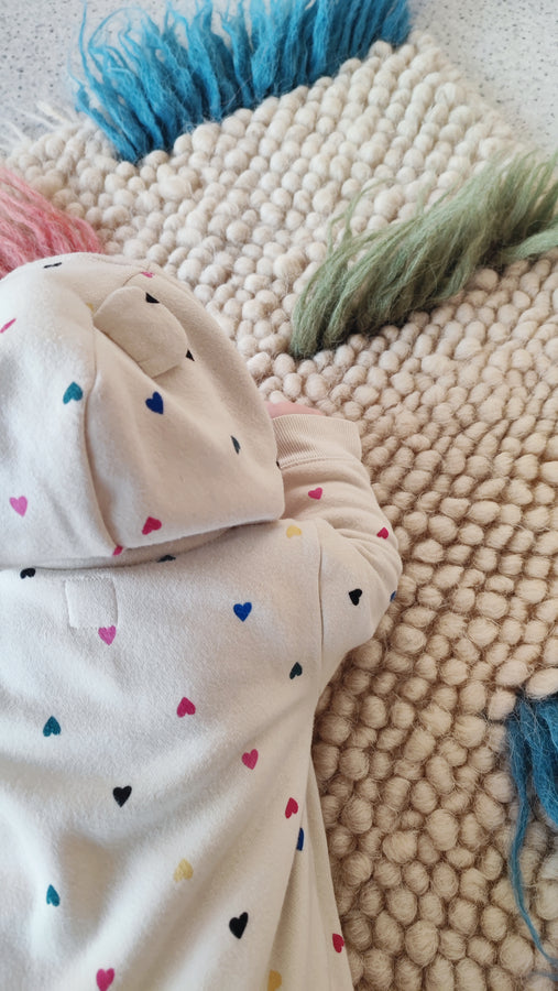 Child playing on the soft woolen Zhvanchyk Gulki textured rug